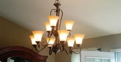 Classic ceiling chandelier installation with warm lighting in Bellevue, WA