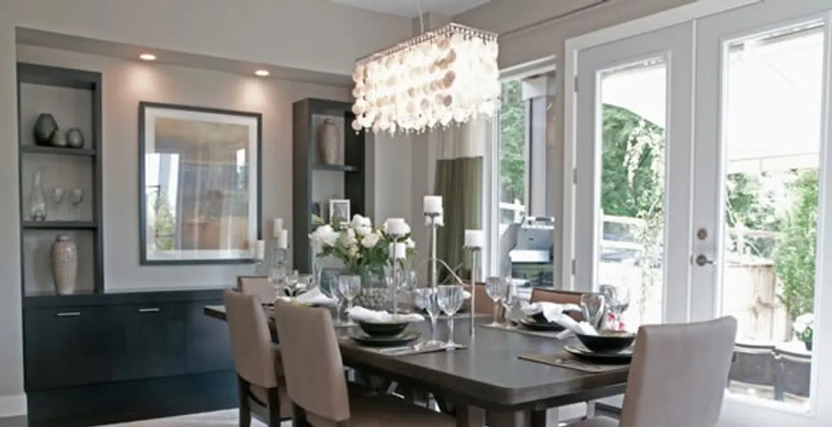 Elegant dining room chandelier installation above table in Bellevue, WA