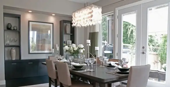 Elegant dining room chandelier installation above table in Bellevue, WA