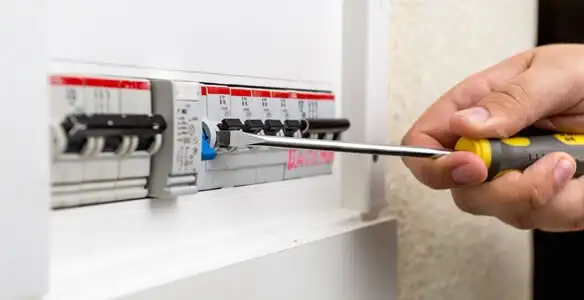 electrical panel upgrade service showing technician adjusting circuit breakers during system upgrade in Bellevue, WA