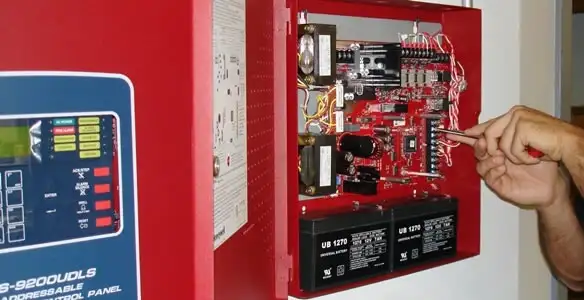 fire alarm installation service showing technician configuring fire alarm control panel in Bellevue, WA