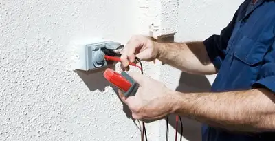 Electrician performing home electrical outlet and wiring inspection in Bellevue, WA