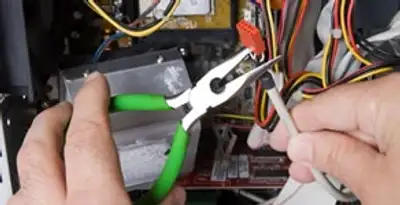 Licensed electrical contractor performing electrical repair with tools in Redmond, WA