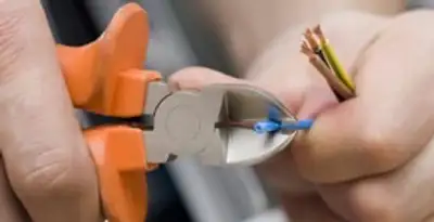 professional electrical services showing precise wire cutting by licensed electricians in Bellevue, WA