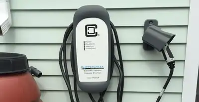 Outdoor electric vehicle charger installation on residential wall in Bellevue, WA