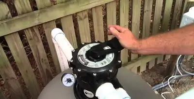 pool pumps service showing professional adjustment of pool pump control system in Bellevue, WA