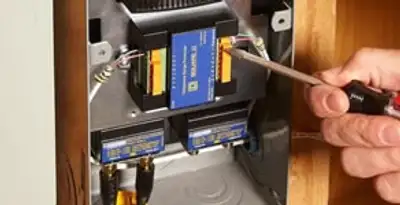 Whole home surge protection device being installed by a licensed electrician to protect electrical systems in Bellevue, WA